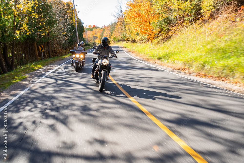 Group of friends riding motorcycles in the fall in Canada