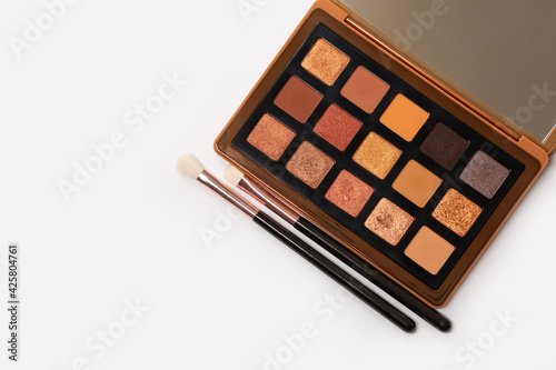 Multicolored eyeshadow palette with makeup brushes