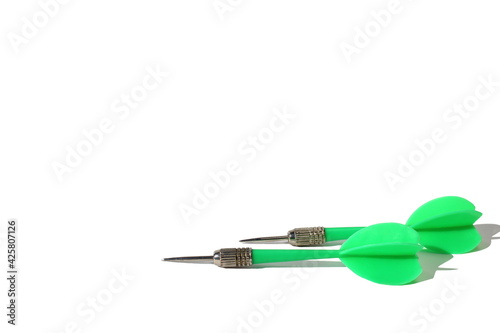 Green dart darts lie on white background with place for text © Снежана Кудрявцева