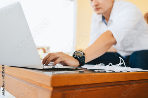 Young businessman working laptop in coffee shop. Business and freelance job concept.