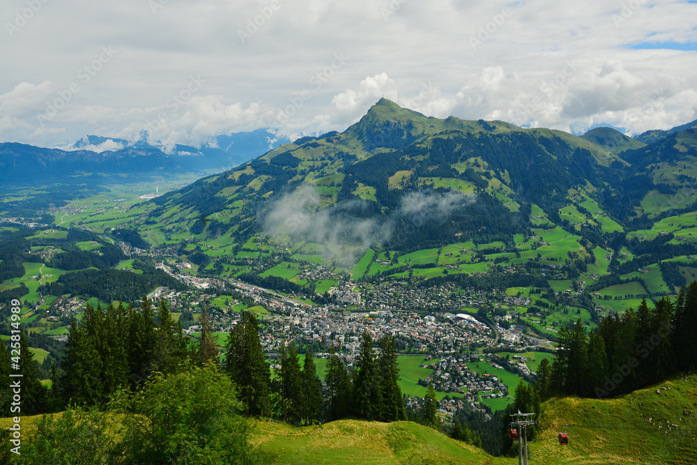 View from the Austrian Alps -  Hahnenkamm ski run on Kitzbuhel town and Kitzbuheler Horn mountains in Tirol, Austria