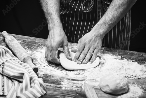Hands of a chef making pizza dough © Nataliya Schmidt