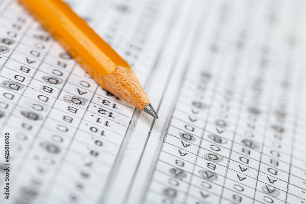 testing in exercise and exam paper. computer sheet with pencil in school test room, education concept. filling in answers in pencil testing in exercise and exam paper. computer sheet with pencil in school test room, education concept. filling in answers in pencil
