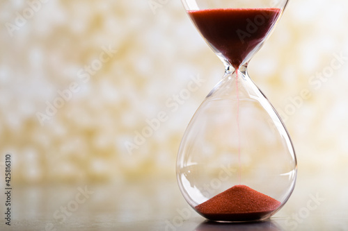 Hourglass as a concept of passing time for business deadline, urgency and outcome of time.