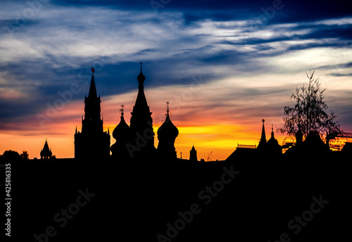 Black silhouette of Cathedral of Vasily the Blessed, Spasskaya Tower and Kremlin. Sunset sky.