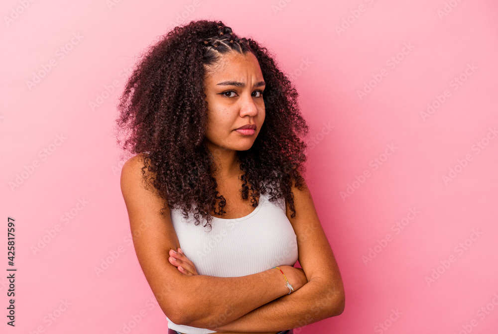 Young african american woman isolated on pink background unhappy looking in camera with sarcastic expression. Young african american woman isolated on pink background unhappy looking in camera with sarcastic expression.