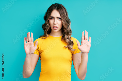 Young woman showing stop gesture with her hands