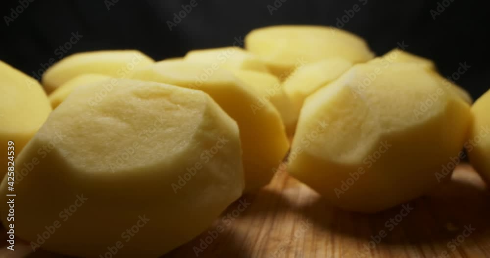 detailed extreme close-up of peeled potatoes on wooden board. detailed extreme close-up of peeled potatoes on wooden board.