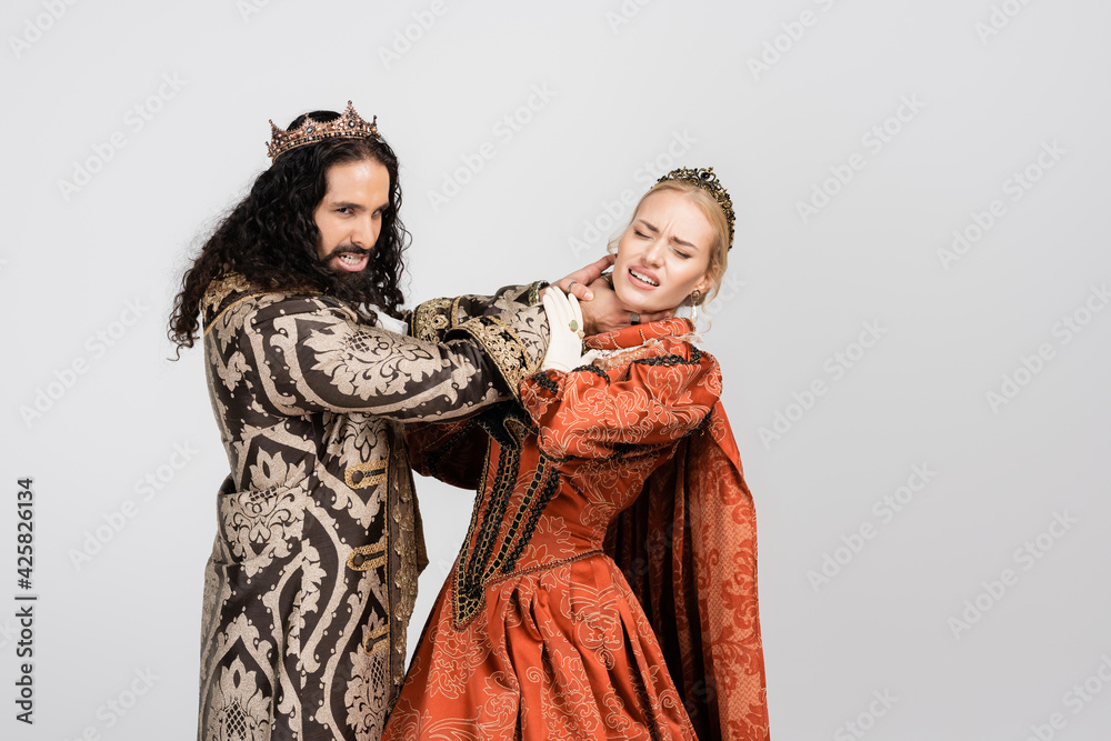 hispanic king in medieval clothing choking scared queen in crown isolated on white