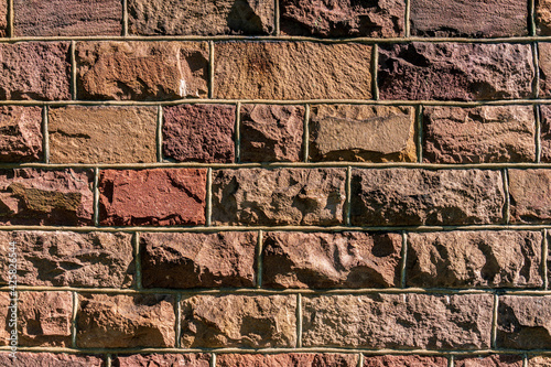 Background from an old rock wall with pink stones