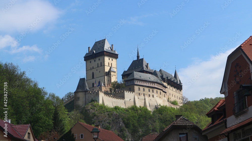 Fototapeta premium A view to the medieval castle Karlstejn with blue sky above at Czech republic