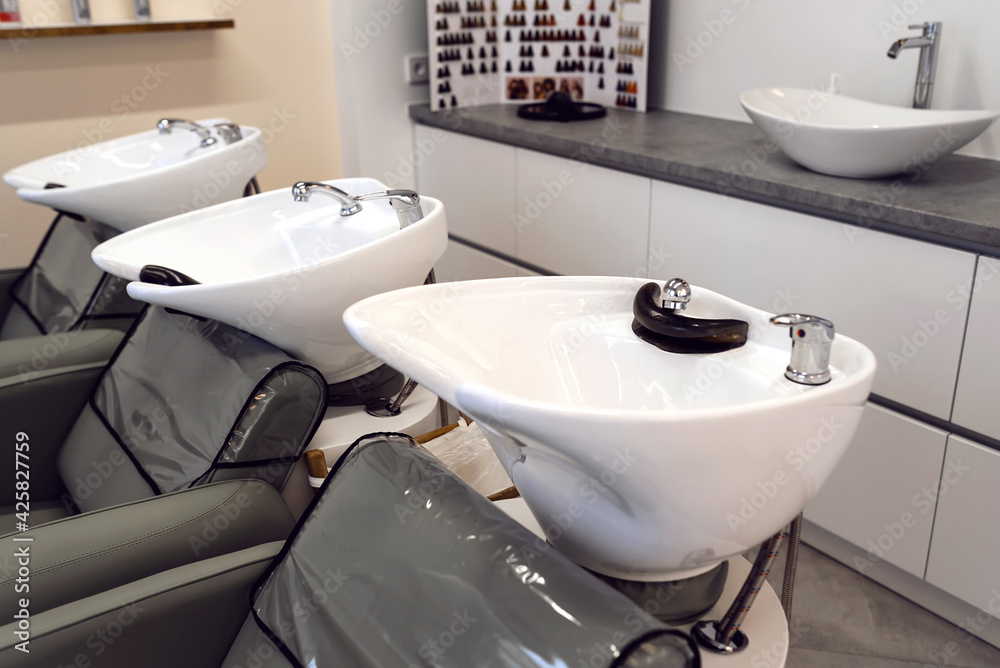 Fototapeta premium Hairdressing salon with hair wash basins chair wiht sink