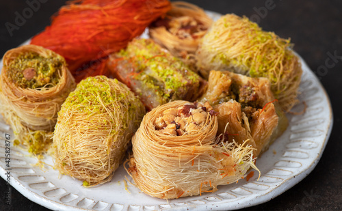 Traditional turkish, arabic sweets baklava assortment with pistachio and knafe (Kunefe, kunafa, kadayif)