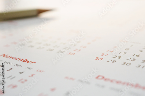 white pencil on calendar background business planning appointment meeting concept