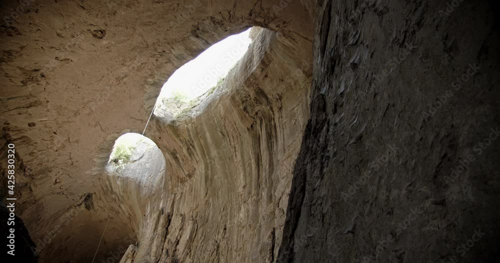 Prohodna cave in Bulgaria with two eye-like holes in its ceiling, known ...