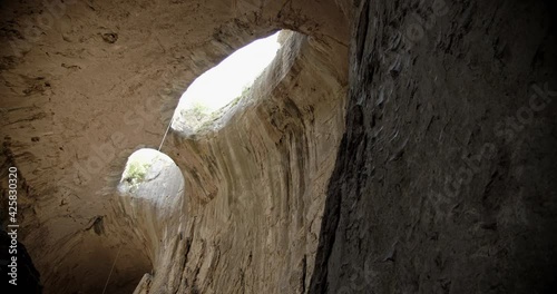 Prohodna cave in Bulgaria with two eye-like holes in its ceiling, known as the Eyes of God. 4k