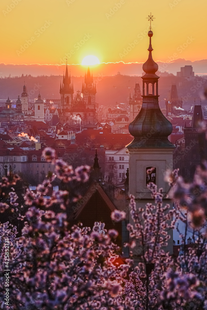 A sun rising above the Prague cityscape in spring.