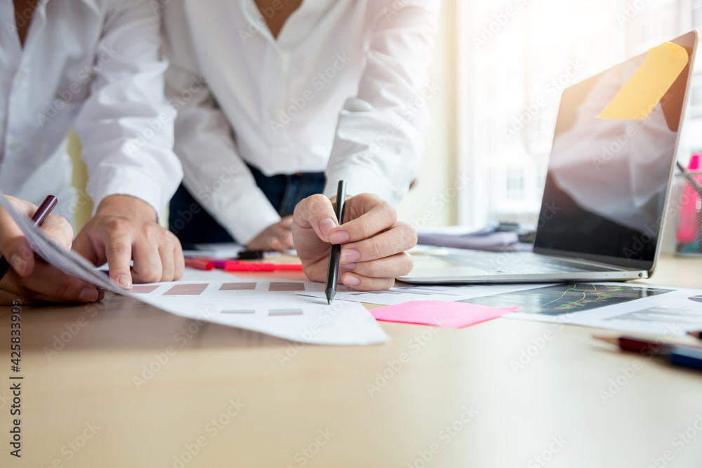 Close-up of a businesswoman hand hold a pen pointing at a document at the office. Close-up of a businesswoman hand hold a pen pointing at a document at the office.