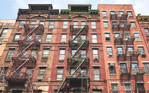 Old brick buildings with fire escapes, New York City, USA.