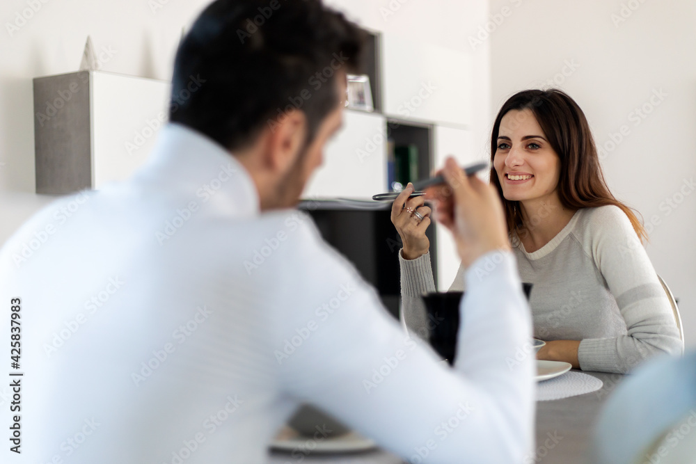 Fototapeta premium Attractive couplehaving a romantic dinner at home alone