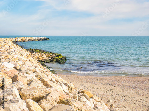 Riprap or rock armour structure for protecting the sea coastline. Black sea waterfront in Constanta, Romania. photo