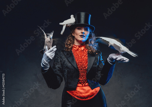 Female perfomer dressed in classic retro clothing posing with doves photo