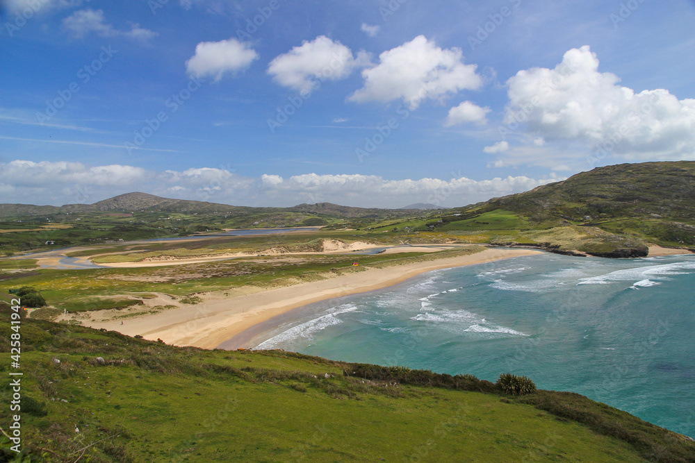 view of the coast with hills and blue sky