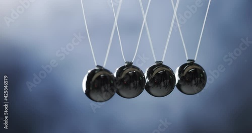 Newton's pendulum - demonstrates the law of energy conservation, momentum is transmitted from one ball to another