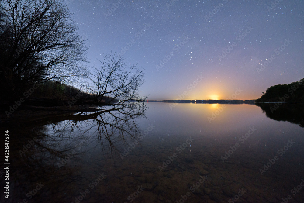 Amazing night starry sky, reflection in the water.