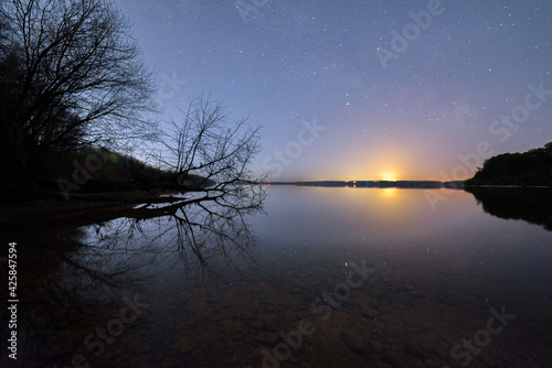 Amazing night starry sky, reflection in the water.
