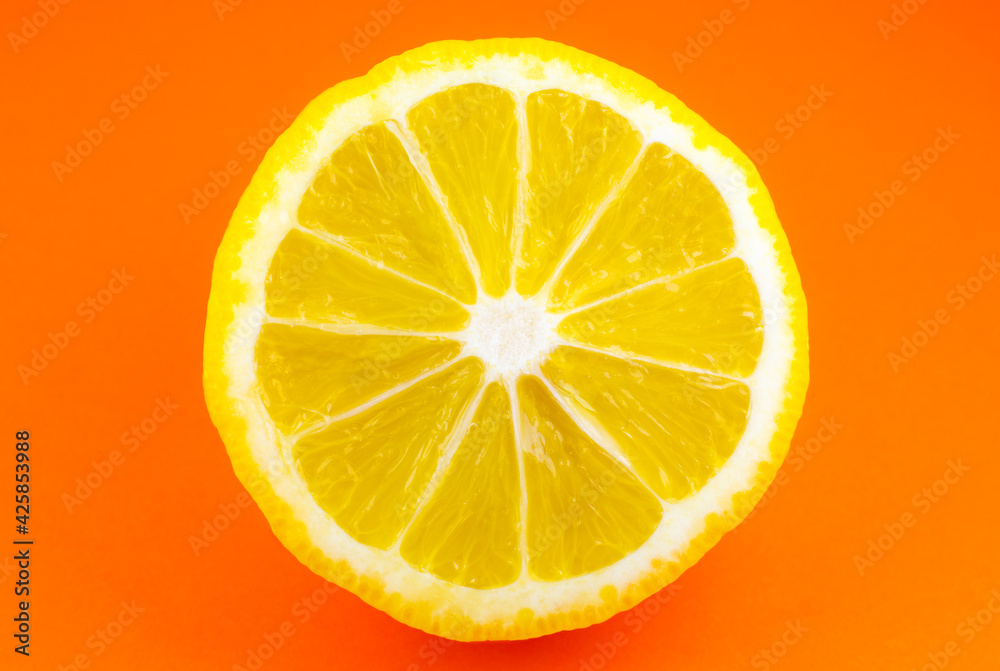 Close up photo of lemon texture on the orange background. Fruit cut in half, inside, macro view. Minimalism, original and creative photo. Close up photo of lemon texture on the orange background. Fruit cut in half, inside, macro view. Minimalism, original and creative photo.
