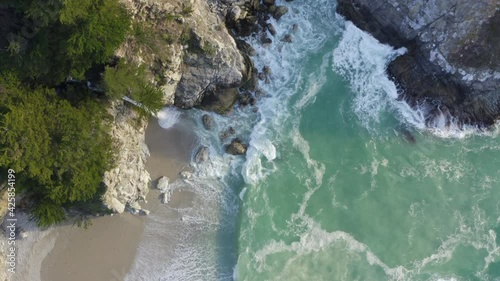Top Down Forward Pan of McWay Falls and Waves Crashing on the Coast of Big Sur