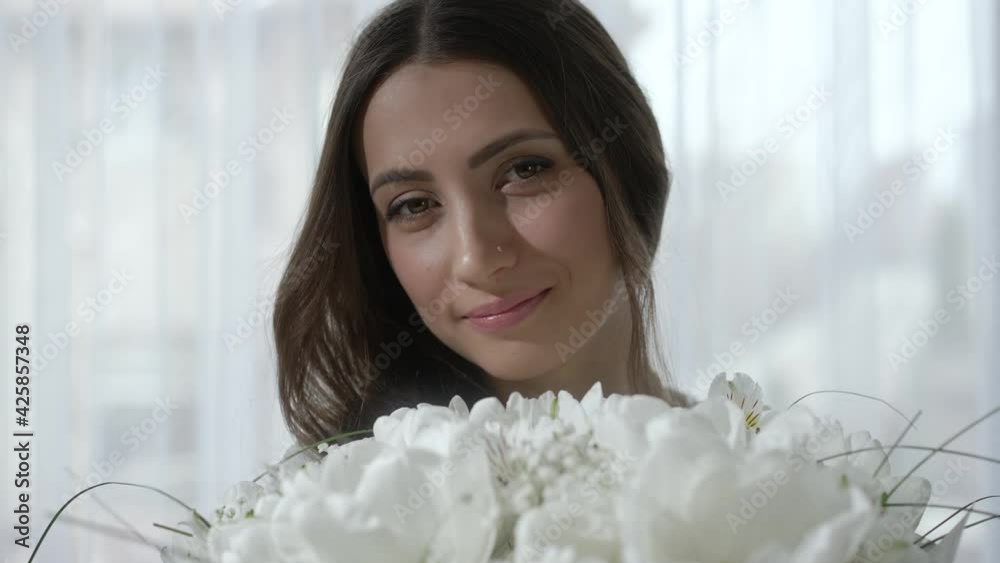Portrait of happy young woman with flowers