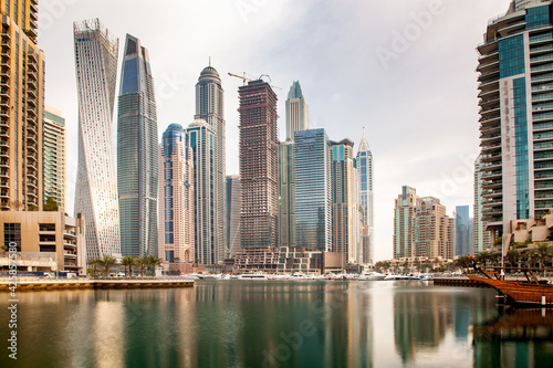 DUBAI, UAE - FEBRUARY 2018: View of modern skyscrapers shining in sunrise lights in Dubai Marina in Dubai, UAE.