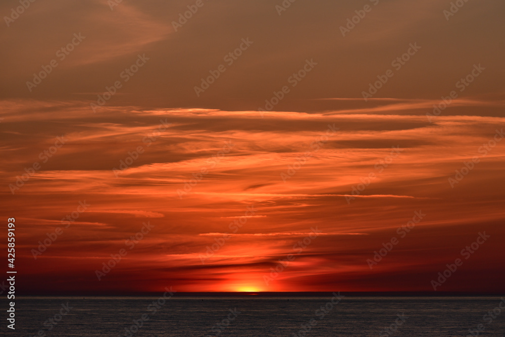 sunset at sea with a calm water surface