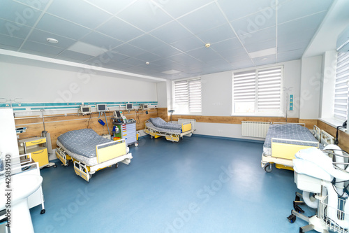 Comfortable equipment for patient with illness. Modern emergency bed in hospital ward.
