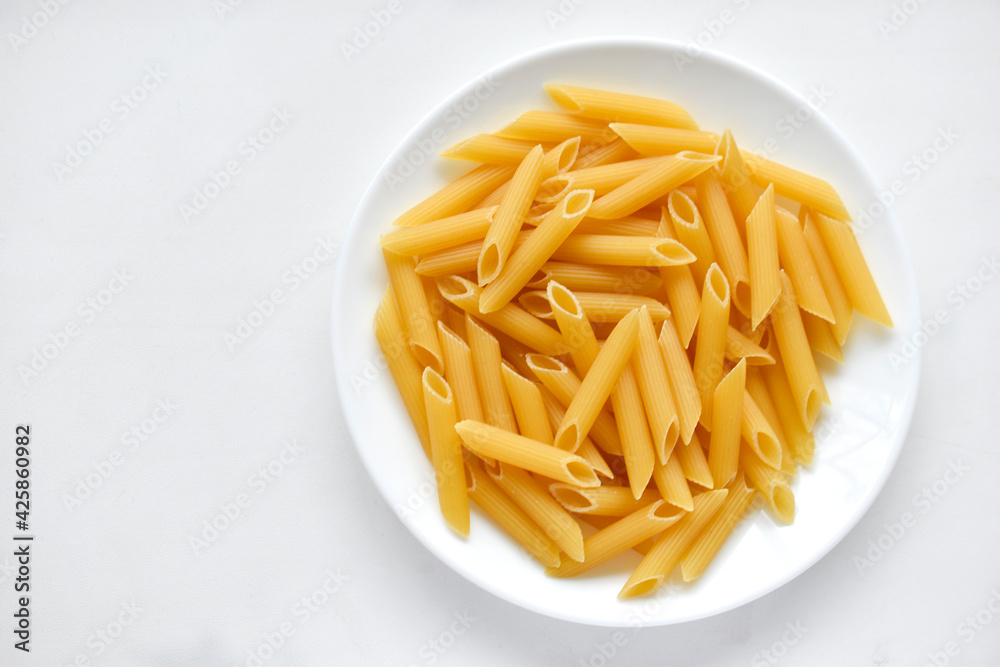 Yellow delicious pasta close-up on a white plate Yellow delicious pasta close-up on a white plate