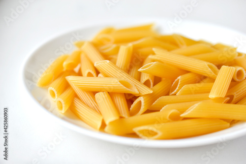 Yellow delicious pasta close-up on a white plate