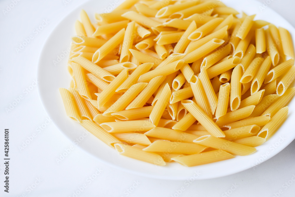 Yellow delicious pasta close-up on a white plate Yellow delicious pasta close-up on a white plate