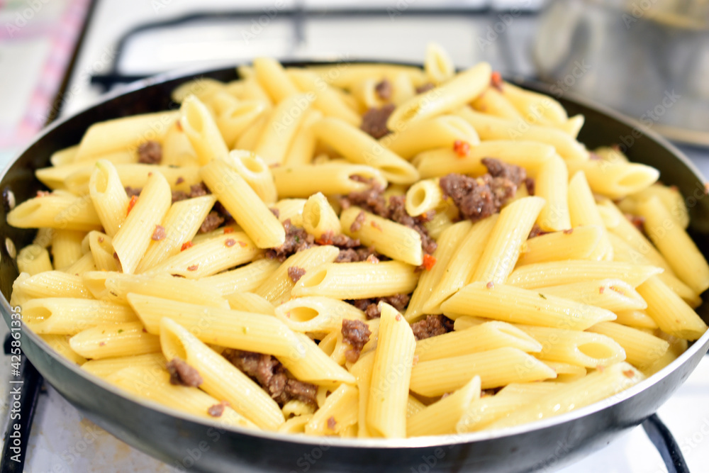 Freshly washed Italian pasta in a frying pan Freshly washed Italian pasta in a frying pan
