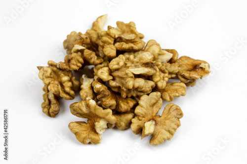 Walnuts, a bunch of peeled walnuts on a white background. Walnut kernels isolated on a white background. Pieces of pulp of walnuts.