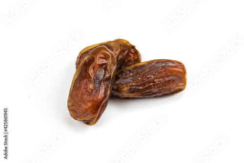 Three date fruits. Fruit dates. Three dates isolated on a white background. Three dates close up, macro.
