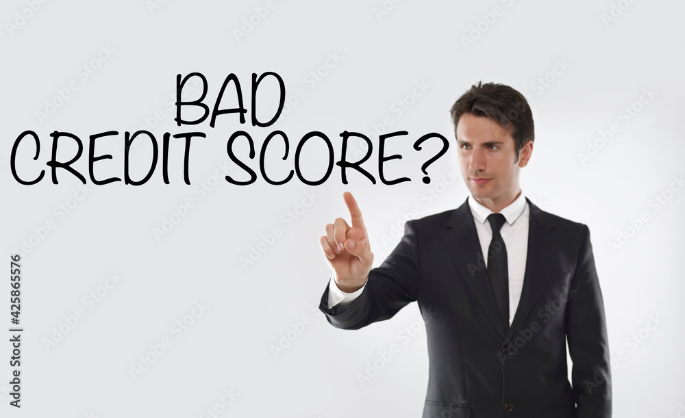 Man touching on a touchscreen with “Bad credit score?” text Man touching on a touchscreen with “Bad credit score?” text