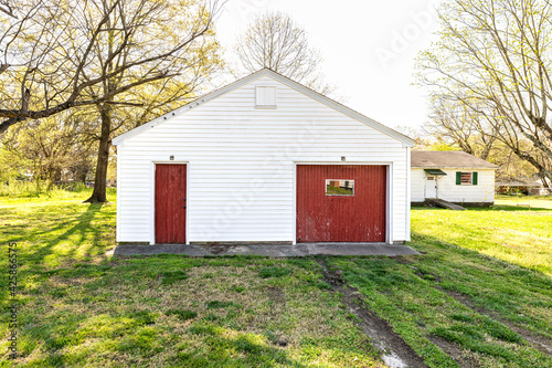 White Shed Barn with Red Garage Door