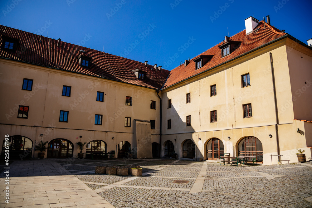 Medieval gothic castle Kadan at royal city, Town fortification, fortress wall on sunny day, courtyard with arcades, historical building at the top of the hill, Kadan, Czech Republic
