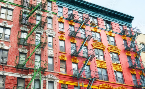 Old colorful buildings with fire escapes, New York City, USA.