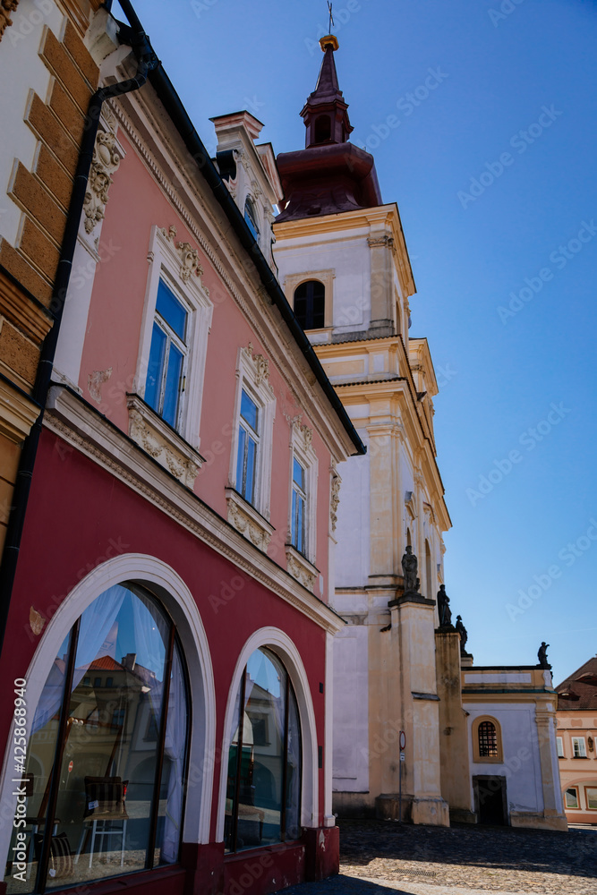 Church of Exaltation of the Holy Cross, Main town Peace square, Medieval narrow street, gothic, renaissance and baroque historical buildings, sunny day, Kadan, Czech Republic