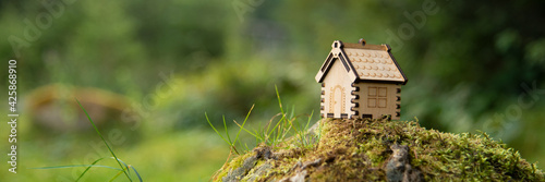 Wooden house model in a forest Eco house concept