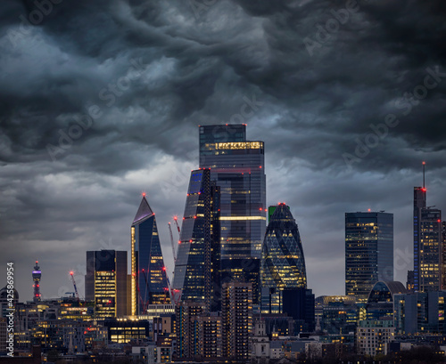 Photography The illuminated skyscrapers of the City of London with dark clouds above them, U