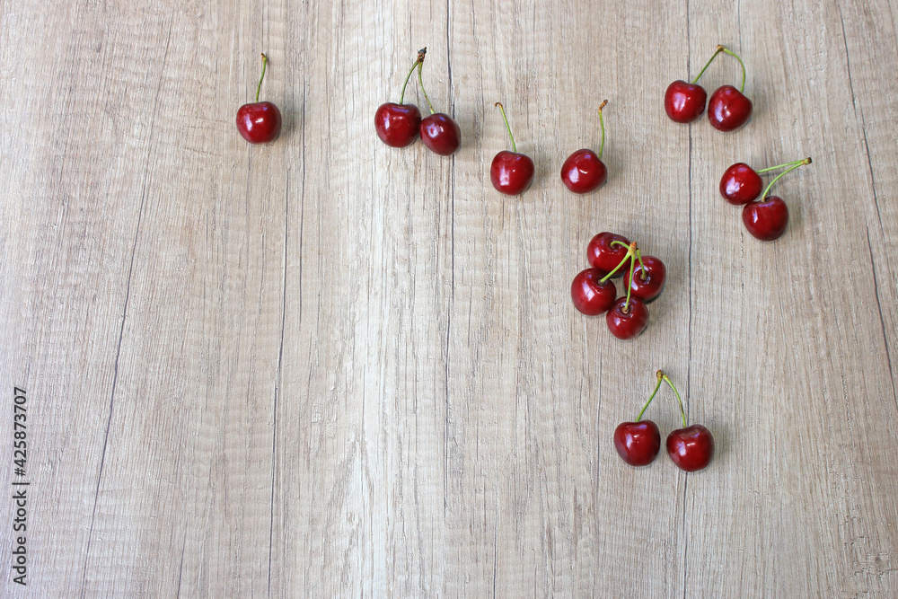 Fresh cherries on wooden background, close up of juicy ripe fruit Fresh cherries on wooden background, close up of juicy ripe fruit